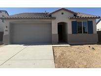 Charming single-story home featuring a neutral color scheme, a two-car garage, and a well-maintained front yard at 22360 W Monona Ln, Surprise, AZ 85387