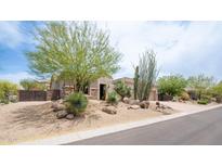 Charming single-story home featuring desert landscaping, mature trees, and an inviting entrance at 28019 N 115 Pl, Scottsdale, AZ 85262