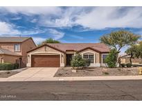 Charming single-story home featuring a two car garage, neutral paint, and a well-manicured front yard at 4346 E Prickly Pear Trl, Phoenix, AZ 85050