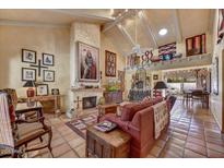 Comfortable living room features a fireplace, tile flooring, and access to the dining area at 5738 N Scottsdale Rd, Scottsdale, AZ 85253