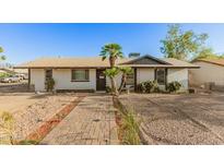Charming single-story home with desert landscaping and a brick walkway leading to the front door at 8717 W Turney Ave, Phoenix, AZ 85037