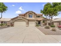 Charming two-story home with a three-car garage, desert landscaping, and a tile roof at 8754 W Karen Lee Ln, Peoria, AZ 85382
