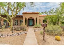 Charming single-story home featuring a tile roof, quaint landscaping and a bright blue front door at 11051 N 45Th Pl, Phoenix, AZ 85028