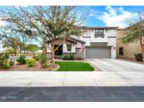 Charming two-story home with a well-maintained lawn, desert landscaping, and a two car garage at 1140 E Vermont Dr, Gilbert, AZ 85295