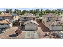 Two-story home featuring a tile roof, two-car garage, and desert landscaping for low maintenance at 11915 W Charter Oak Rd, El Mirage, AZ 85335