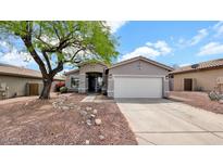Charming single-story home featuring a two car garage, desert landscaping, and a welcoming entryway at 18371 W Sunrise Dr, Goodyear, AZ 85338
