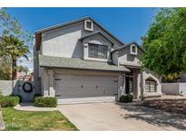 Charming two-story home featuring a well-manicured lawn and an attached two-car garage at 1898 E Kent Ave, Chandler, AZ 85225