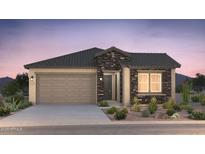 Charming single-story home boasting stone accents, a two-car garage, and well-maintained desert landscaping at 21254 E Cattle Dr, Queen Creek, AZ 85142
