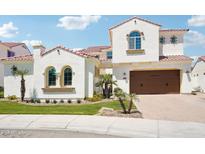 Beautiful two-story home featuring a red tile roof, manicured lawn, and a spacious two car garage at 2454 W Hope Cir, Chandler, AZ 85248