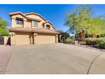 Inviting home featuring a three-car garage, desert landscaping, and a tile roof at 29023 N 46Th Way, Cave Creek, AZ 85331