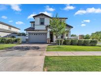 Charming two-story home with a well-maintained front yard and a spacious two-car garage at 3415 E Arabian Dr, Gilbert, AZ 85296