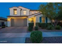 Charming two-story home with a well-manicured lawn and a two-car garage at dusk at 4337 S Helix --, Mesa, AZ 85212