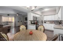 Modern kitchen with stainless steel appliances and granite countertops open to dining area at 4554 E Paradise Village Pkwy # 267, Phoenix, AZ 85032