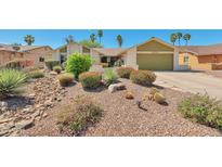 Charming single-story home featuring desert landscaping, a two-car garage, and a well-maintained front yard at 4815 E Everett Dr, Scottsdale, AZ 85254