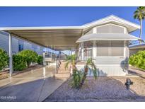 Charming manufactured home with covered parking, landscaped front, and easy access stairs at 7750 E Broadway Rd # 361, Mesa, AZ 85208