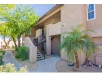 Condo exterior featuring desert landscaping and stairs to the second level at 9451 E Becker Ln # 2016, Scottsdale, AZ 85260