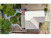 An aerial view showcases the home's spacious backyard, landscaping, and covered patio at 13261 W Gelding W Cir, Surprise, AZ 85379
