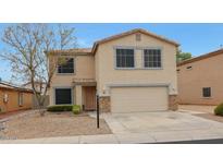 Charming two-story home featuring a well-maintained yard, attached garage, and beautiful exterior finishes at 13261 W Gelding W Cir, Surprise, AZ 85379