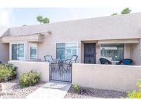 Charming gated front patio with seating area for outdoor relaxation and curb appeal at 14300 W Bell Rd # 222, Surprise, AZ 85374