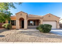 Charming single-story home with desert landscaping, a cozy porch, and an attached two-car garage at 16600 W Washington St, Goodyear, AZ 85338