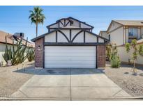 Charming home featuring a two-car garage, red brick accents, and a well-manicured front yard with desert landscaping at 1915 S 39Th St # 37, Mesa, AZ 85206