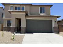 Charming two-story home featuring a two-car garage, neutral color palette, and well-maintained landscaping at 22382 W Monona Ln, Surprise, AZ 85387