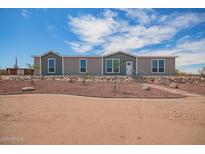 Charming single-story home featuring a well-maintained yard with desert landscaping and a welcoming entrance at 2248 S Nikki Ln, Maricopa, AZ 85139