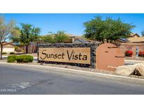 Community sign for Sunset Vista with mature landscaping and neighborhood homes in the background at 25617 W St James Ave, Buckeye, AZ 85326