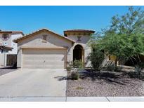 Charming single-story home featuring a two-car garage and desert landscaping under a clear blue sky at 2614 W Fawn Dr, Phoenix, AZ 85041