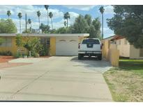 Charming single-story home featuring a spacious driveway and well-maintained landscaping at 3041 E Osborn Rd, Phoenix, AZ 85016