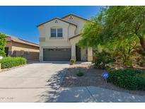 Two story home featuring an attached garage, desert landscaping, and an ADT security system at 3443 W Saint Anne Ave, Phoenix, AZ 85041