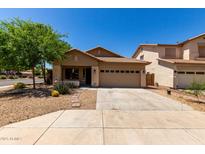 Charming single-story home featuring a well-maintained front yard and a two-car garage at 4216 N Dania Ct, Litchfield Park, AZ 85340