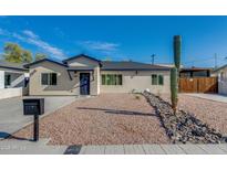 Charming single-story home with a xeriscaped front yard and a classic desert-inspired landscape at 542 E Flynn Ln, Phoenix, AZ 85012