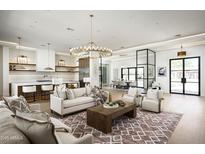 Spacious living room featuring a modern chandelier, sleek kitchen, and open layout perfect for entertaining at 7001 E Joan De Arc Ave, Scottsdale, AZ 85254