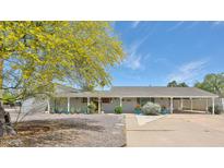 Attractive single-story home featuring desert landscaping, a covered front porch, and a convenient carport at 9851 N 28Th Way, Phoenix, AZ 85028