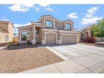 Charming two-story home featuring a three-car garage, neutral color palette and low maintenance front yard at 12745 W Calavar Rd, El Mirage, AZ 85335