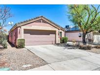 Charming single story home featuring a two-car garage, low maintenance landscaping, and a neutral color palette at 12938 W Mandalay Ln, El Mirage, AZ 85335