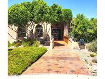 Charming front entrance with tiled walkway, mature trees, and desert landscaping at 1338 W Mountain View Dr, Mesa, AZ 85201