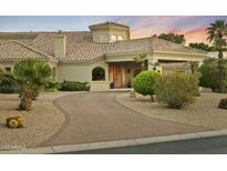 Charming home featuring lush landscaping, a curved driveway, and desert-friendly greenery at 14123 W Greentree S Dr, Litchfield Park, AZ 85340