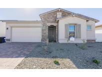 Charming single-story home featuring stone accents, a two-car garage, and desert landscaping at 16355 W Desert Mirage Dr, Surprise, AZ 85388