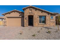 Charming stone-accented home with a two-car garage and a paved driveway at 18950 W Ocotillo Rd, Waddell, AZ 85355