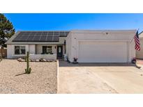 Charming single-story home with solar panels, a two-car garage, and low-maintenance desert landscaping at 19413 N 8Th St, Phoenix, AZ 85024
