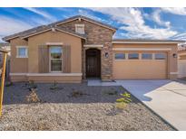 Charming single-Gathering home with a well-manicured front yard, stone accents, and inviting curb appeal at 257 S 165Th Ave, Goodyear, AZ 85338