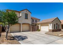 Charming home with a three-car garage and lush desert landscaping, complete with a private gated courtyard at 2718 S Cupertino Dr, Gilbert, AZ 85295