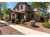 Charming two-story home with a well-maintained front yard and a welcoming entrance and beautiful landscape at 4068 E Devon Dr, Gilbert, AZ 85296