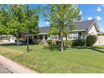 Charming single-story home with a spacious front yard and mature trees at 4111 N 52Nd St, Phoenix, AZ 85018