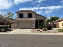 Charming two-story home features a well-maintained front yard and a two-car garage at 7176 W Blackhawk Dr, Glendale, AZ 85308