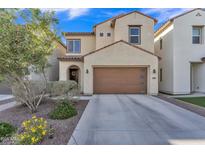 Charming two-story home featuring a brown garage door and manicured landscaping in a well-maintained neighborhood at 7234 W Aire Libre Ave, Peoria, AZ 85382