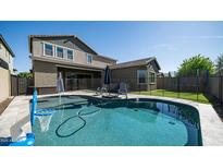 Private backyard with a refreshing pool, and secure fencing at 9936 E Revolution Dr, Mesa, AZ 85212