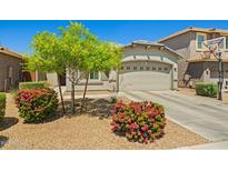 Well-maintained single-story home features desert landscaping, a two-car garage and a basketball hoop at 12416 W Midway Ave, Glendale, AZ 85307